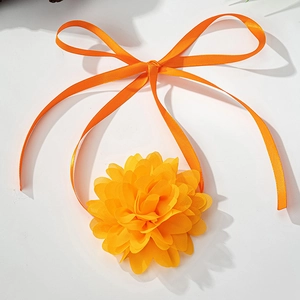 Detailed view of orange fabric rose flower choker with elegant long satin ribbons