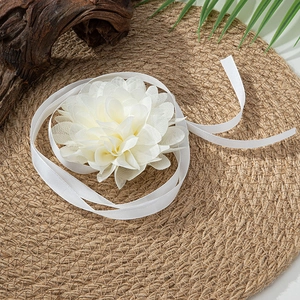 Detailed macro view of white tulle fabric rose choker with elegant silk ribbons