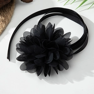 Detail of a large black mesh flower choker with elegant long satin ribbon ties