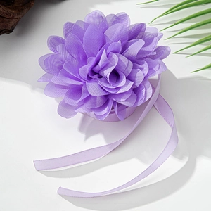 Macro detail of lavender fabric flower chocker with layered mesh petals and silk ribbons