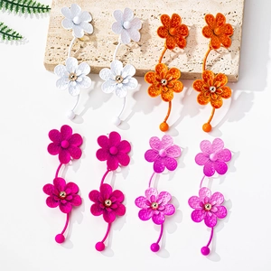 Detail view of large geometric flower earrings with colorful matte lacquer finish