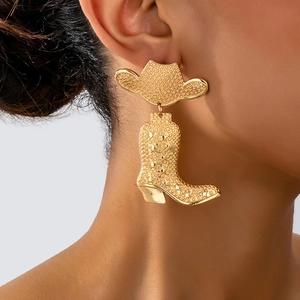Detailed view of gold western cowboy hat and boot earrings with textured star relief