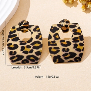 Detail view of leopard print geometric hexagon earrings with size and weight dimensions