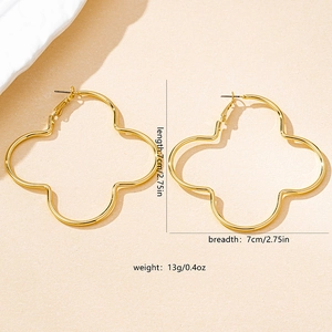 Flat lay of gold hollow-out four-leaf clover hoop earrings with size 7cm x 7cm 13g specs
