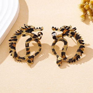 Detail of golden dragon hoop earrings with leopard print finish and textured beads