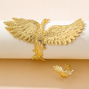 Detailed close-up of golden phoenix hair accessory and brooch with intricate feather textures