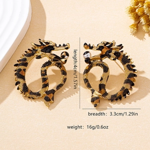 Detailed macro view of dragon earrings with black-gold leopard texture and striped beads
