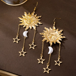 Detail of vintage sun and moon drop earrings with celestial stars and crescent charm