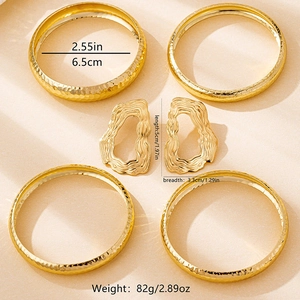 Detail view of gold textured bangles and earrings set with precise size measurements