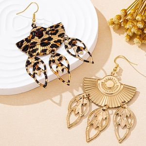 Detail of fan-shaped ethnic earrings with hollow leaf pendants and leopard print patterns