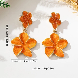 Detailed view of orange Plumeria flower earrings with gold plating and enamel finish