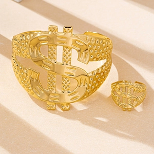 Detail of gold hip-hop jewelry set featuring dollar sign design and dot embossing