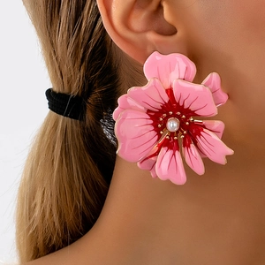 Pink camellia flower stud earrings with a central white pearl in a layered petal design