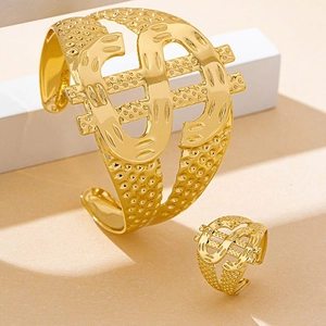 Detail of gold dollar sign jewelry set with adjustable cuff bracelet and matching ring
