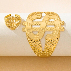 Detailed view of hip-hop style golden dollar sign open ring and cuff bracelet set on a stand