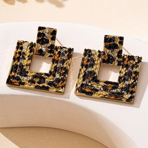 Macro shot of geometric square leopard print earrings with sparkling rhinestone accents