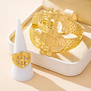 Detail of gold dollar sign cuff bracelet and matching ring set with textured finish