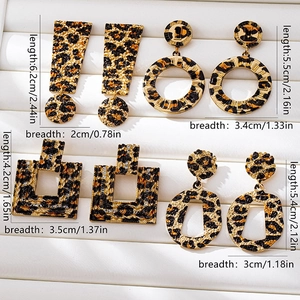 Close-up of leopard print earring set featuring geometric shapes and measurement details