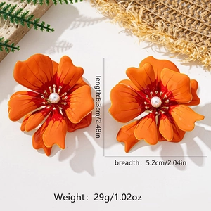 Close-up of orange enamel camellia flower earring with a pearl center and size metrics
