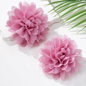 Nahaufnahme von rosa Stoffblumen-Ohrringen mit weichen Chiffon-Blütenblättern