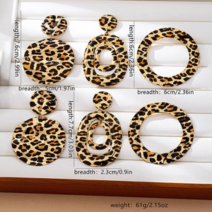 Close-up showing leopard print alloy earrings with detailed size and weight measurements