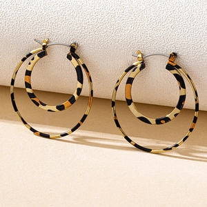 Detail of double hoop earrings featuring a trendy leopard print finish on metal