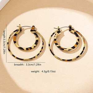 Detail view of gold double-hoop earrings with leopard print and size measurements