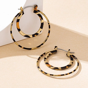 Macro shot of double round gold earrings with high-quality leopard print patterns