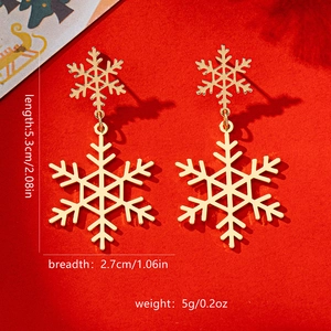 Detailed view of gold snowflake earrings with measurements of 5.3cm length and 2.7cm width