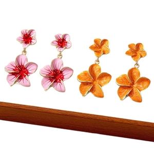Handcrafted floral drop earrings with pink and orange enamel flowers on gold metal