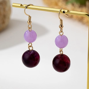 Vintage style double bead drop earrings with purple and burgundy tones on gold hooks