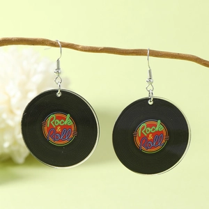 Retro vinyl record earrings with Rock & Roll print hanging on a branch outdoors