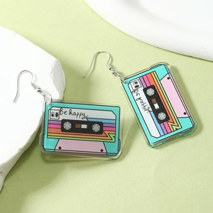 Detail of retro colorful acrylic cassette tape earrings with Be Happy text and metal hooks