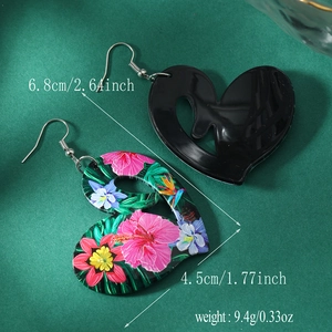 Detail showing dimensions of heart-shaped acrylic earrings with tropical floral pattern