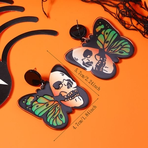 Macro shot of Halloween acrylic butterfly skull earrings with measurement details