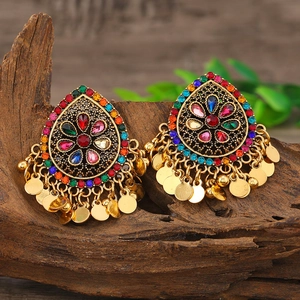 Detalle de pendientes boho con diamantes de imitación coloridos y monedas de oro