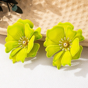 Detail of vibrant green flower earrings with matte finish and gold center core