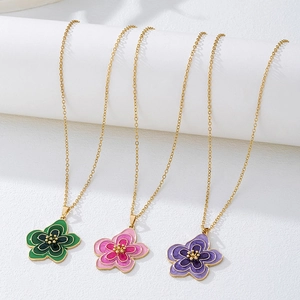 Détail de pendentifs fleurs en émail coloré sur chaînes dorées en vert rose et violet