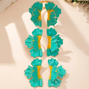 Detailed macro view of ginkgo leaf napkin rings with green enamel and gold finish