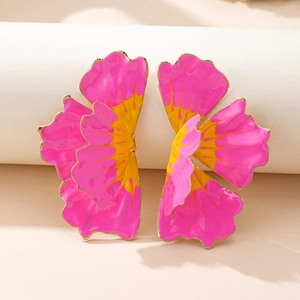 Detailed view of large 3D layered flower earrings with pink and yellow enamel and gold trim