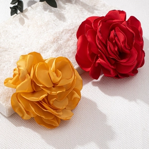 Elegant fabric rose brooches in red and ginger yellow colors with layered silk texture