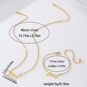 Golden Baby letter pendant necklace and bracelet set on a textured white background