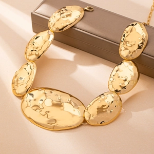 Irregular geometric gold body chain with hammered metal texture for stylish women