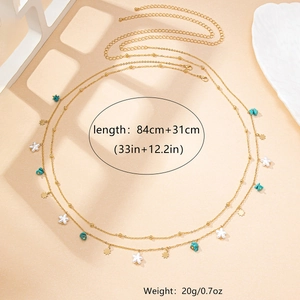 Detail of bohemian gold waist chain with star charms and turquoise beads in soft light