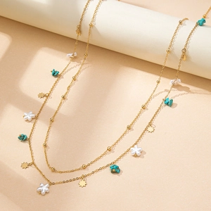 Elegant gold double-layered waist chain with blue stones, pearls, and star charms