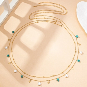 Detail of double-layer gold waist chain with turquoise, stars, and adjustable lobster clasp