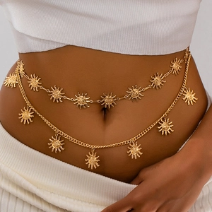 Detailed close-up of double-layer gold waist chain with intricate sun face pendants