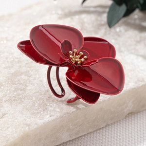 Makro-Detail des glänzenden roten Blumenrings mit goldenen Staubblättern und offenem Ring
