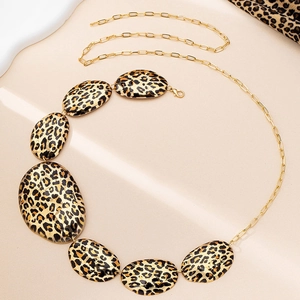Detailed view of leopard print oval plates and golden alloy chain for waist decoration