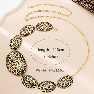 Detail view of leopard print oval charms on a gold waist chain with product dimensions